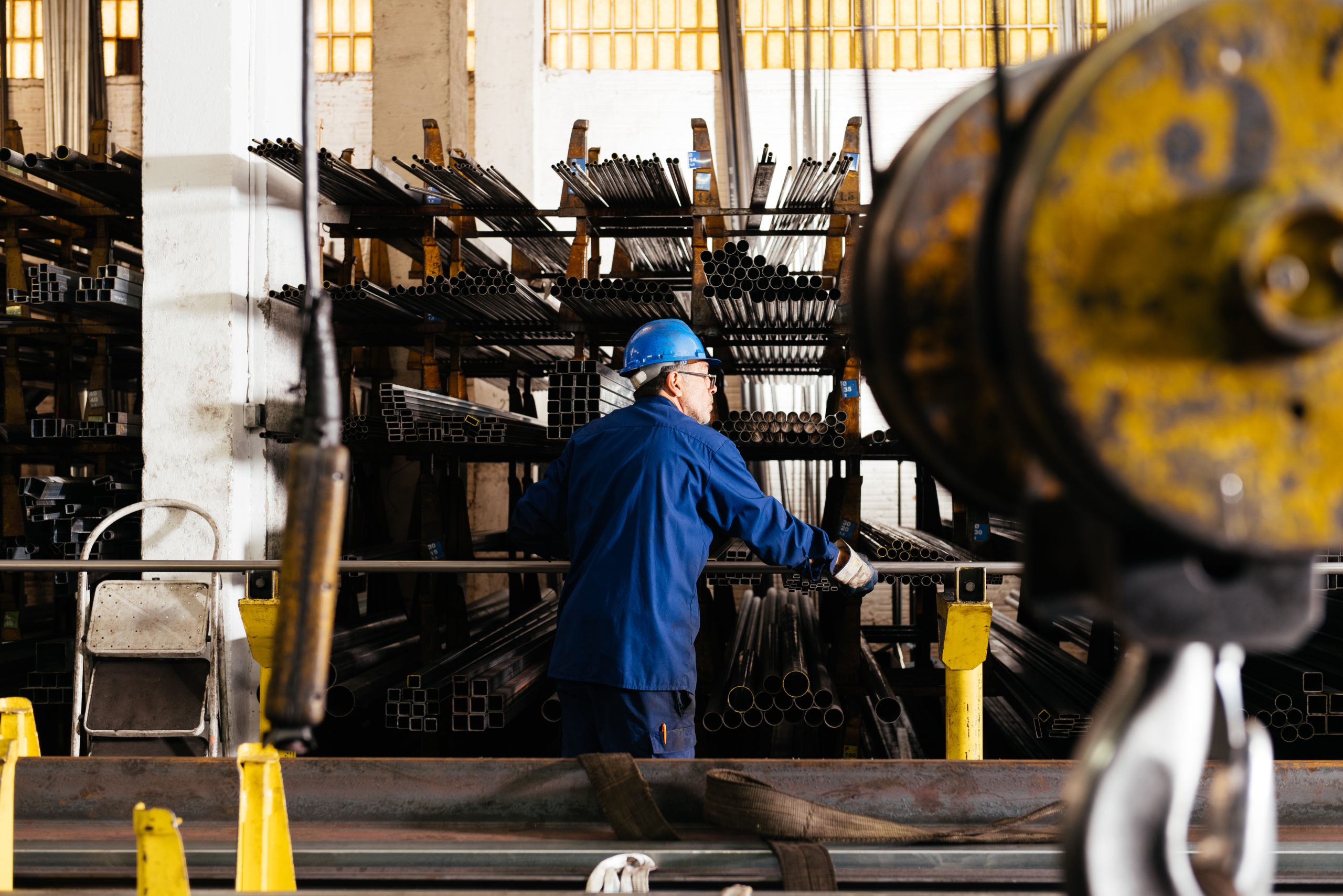 Concentrated factory male worker working with pipes