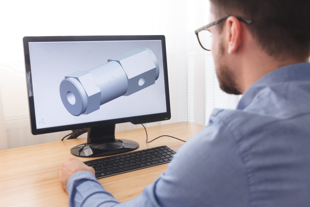 Engineer, Constructor, Designer in Glasses Working on a Personal Computer. He is Creating, Designing a New 3D Model of Mechanical Component in CAD Program. Freelance Work, LOS ANGELES, CALIFORNIA - 25.10.2019.