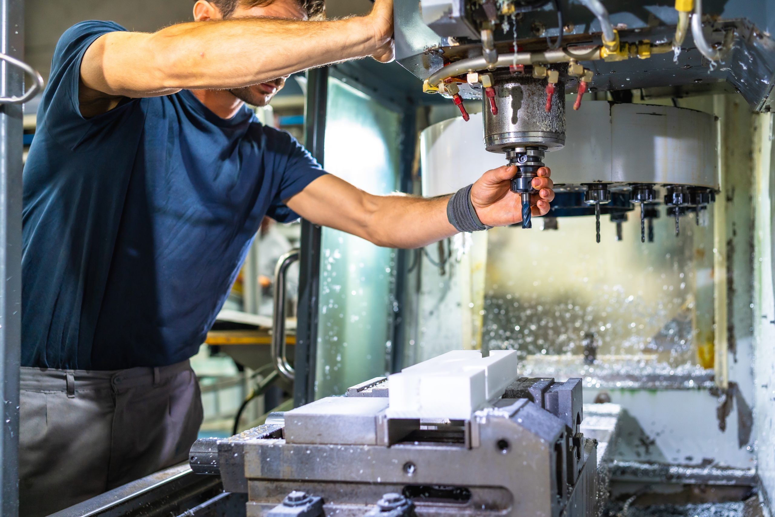 Man working in the machining center for plastic parts