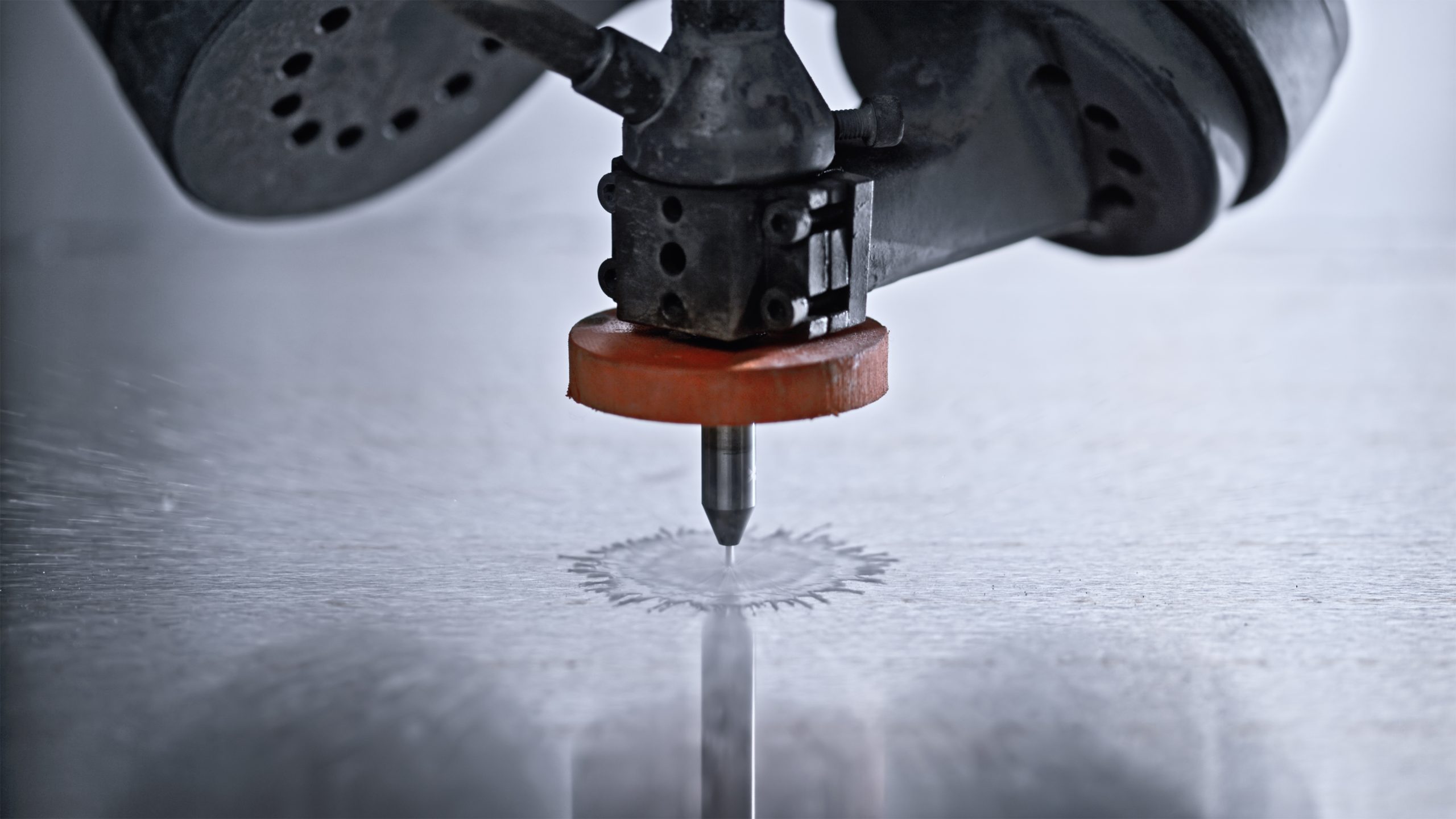 Industrial Water Jet Cutting Machine Head Operating on Metal Surface